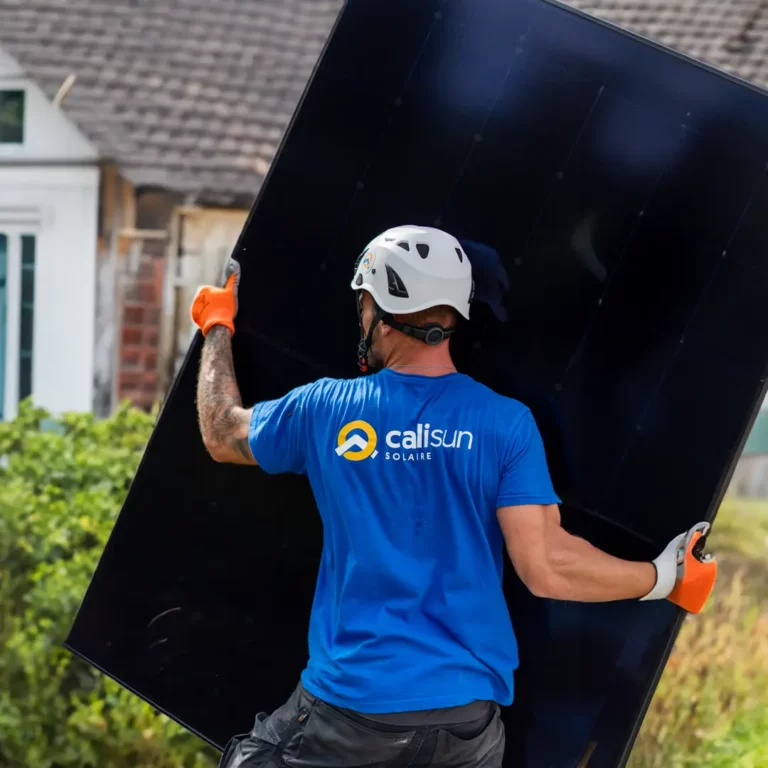 Technicien Calisun manipulant un panneau solaire lors d’une installation photovoltaïque sur maison individuelle dans le Grand Est.